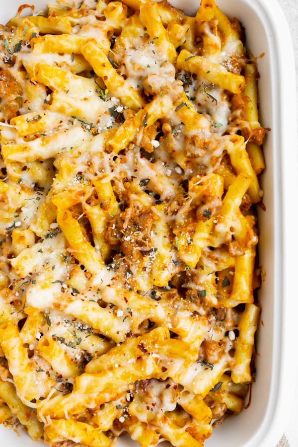 Creamy Pumpkin Baked Ziti in a white casserole dish