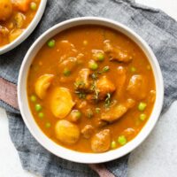 instant pot pumpkin beef stew in a bowl sitting on a napkin