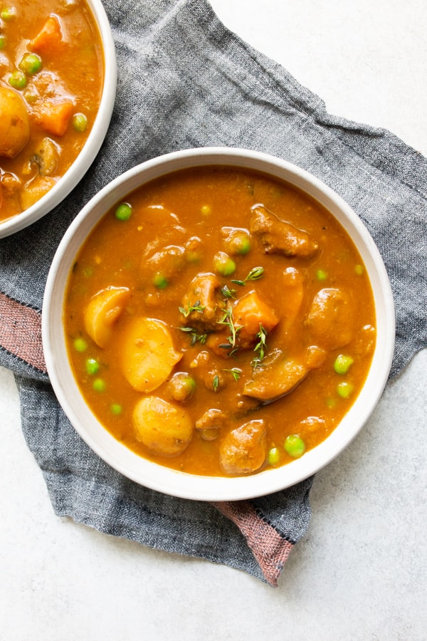 instant pot pumpkin beef stew in a bowl sitting on a napkin