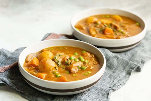 instant pot pumpkin beef stew in a bowl sitting on a napkin