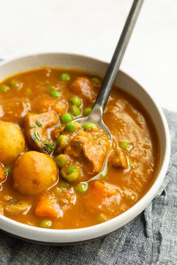 instant pot pumpkin beef stew in a bowl with a spoon