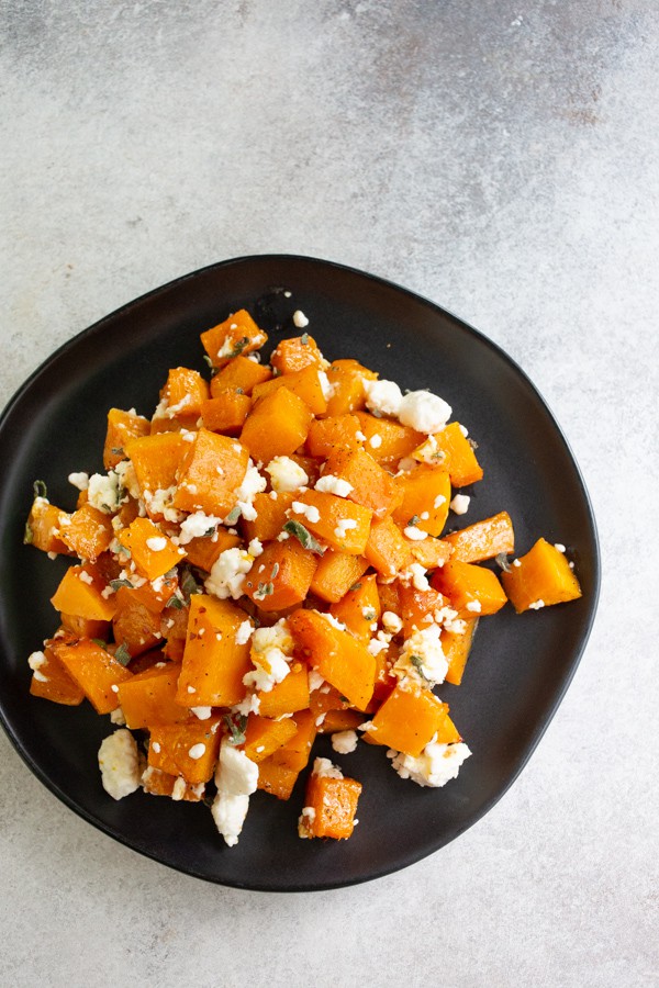 honey roasted butternut squash served on a black plate
