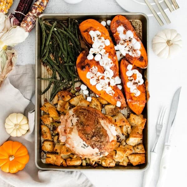 sheet pan thanksgiving dinner on a sheet pan surrounded by fall decor