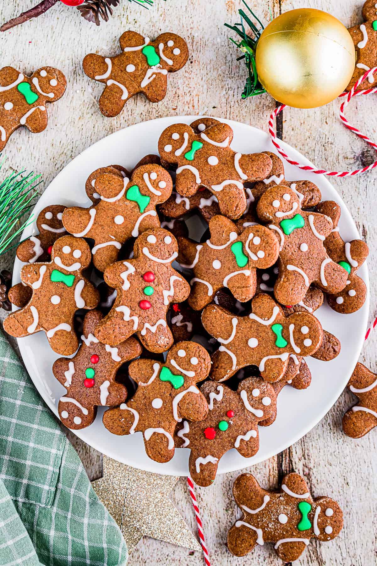 Soft gingerbread cutout cookies on a white plate with green napkin