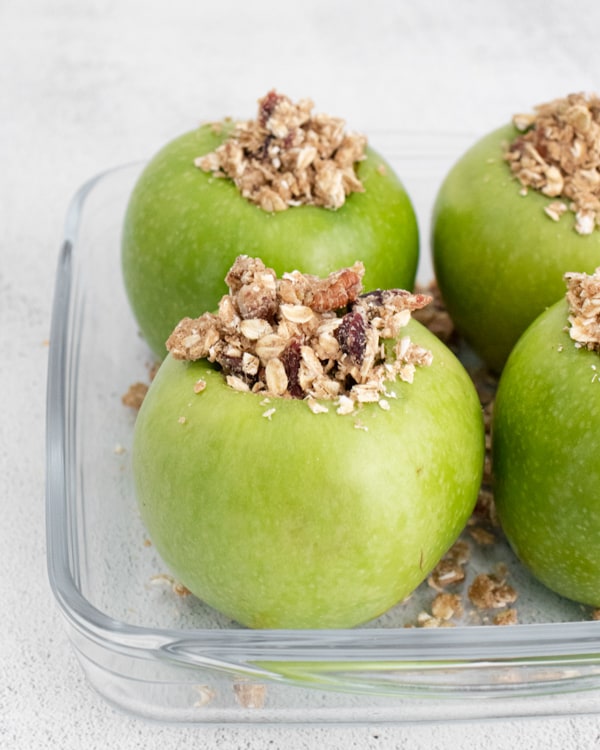 oatmeal stuffed breakfast baked apples in a dish before being baked. 