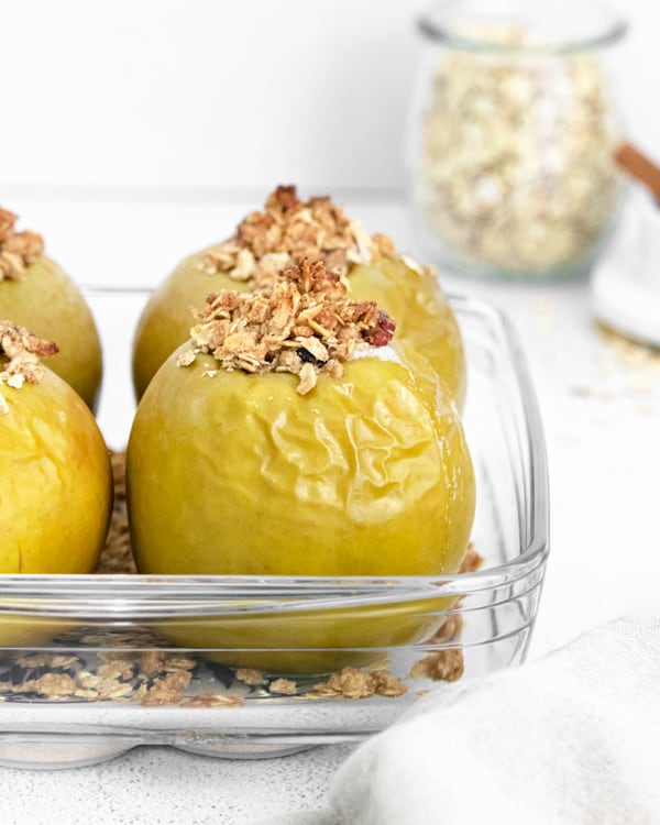 baked apples sitting in a glass casserole dish