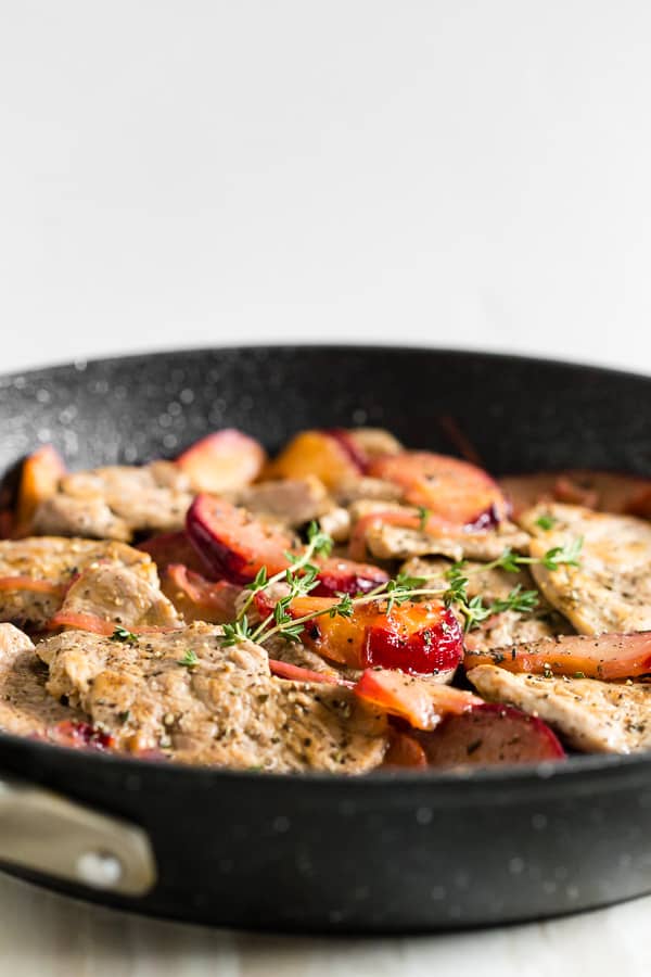 side shot of skillet pork tenderloin with plums