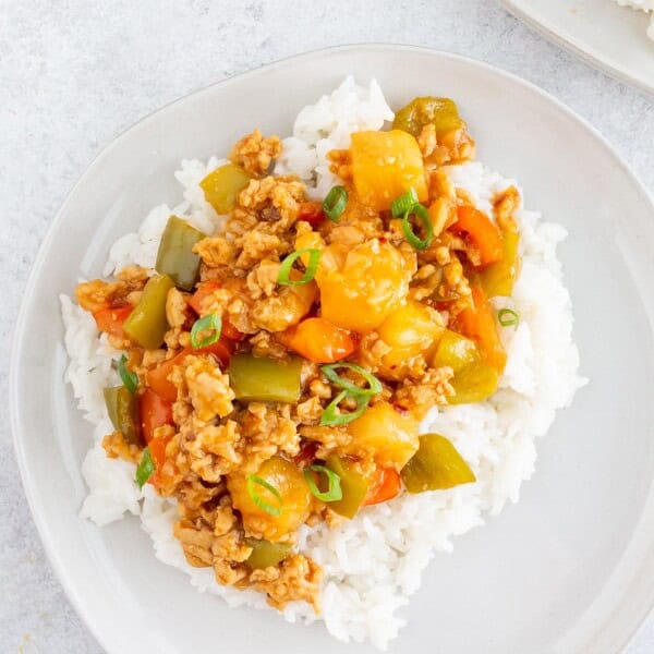 sweet and sour ground chicken on a plate with rice