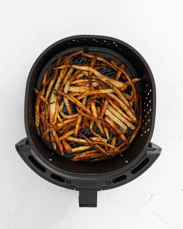 Garlic Parmesan Air Fryer French Fries inside the air fryer basket