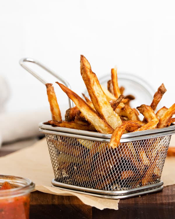 Garlic Parmesan Air Fryer French Fries in a metal basket