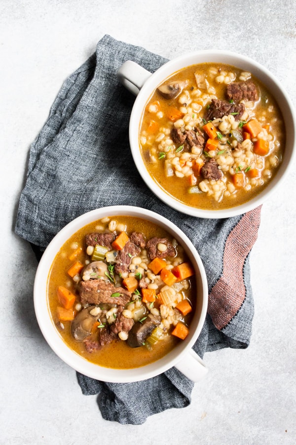 instant pot beef barley soup in cream colored bowls
