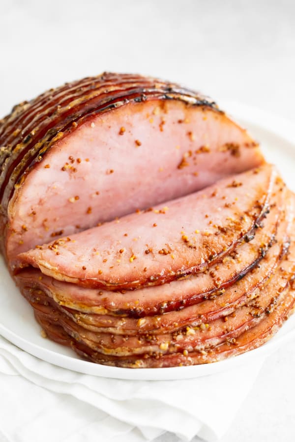 Honey Mustard Baked Ham on a white platter.
