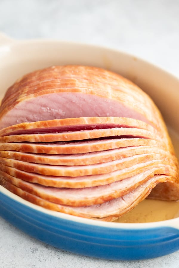 Close up of unbaked spiral ham in baking dish.