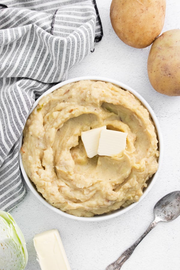 Instant Pot Colcannon Potatoes in a bowl topped with butter. 