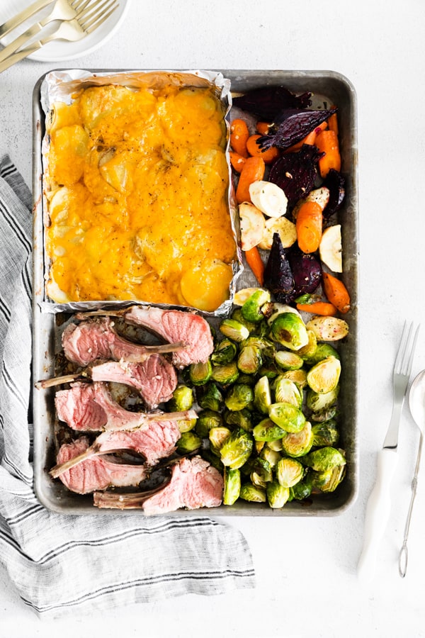 cooked sheet pan easter dinner with carved lamb chops.