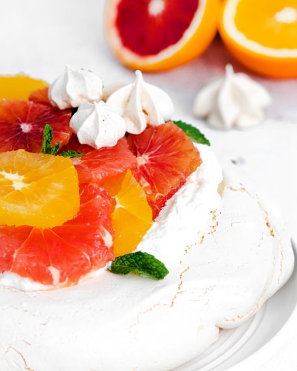 winter citrus fruits on top of a pavlova