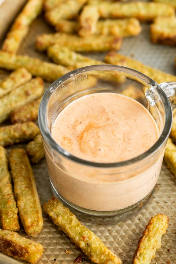 homemade fry sauce in a in a bowl with veggie fries on a baking tray.