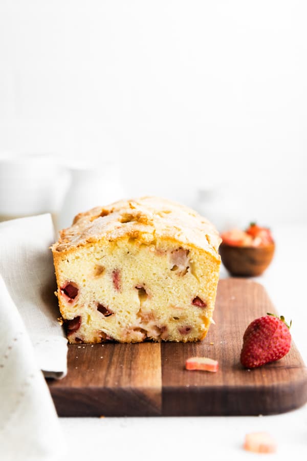 strawberry rhubarb pound cake showing the cut side to see the fresh fruit. 