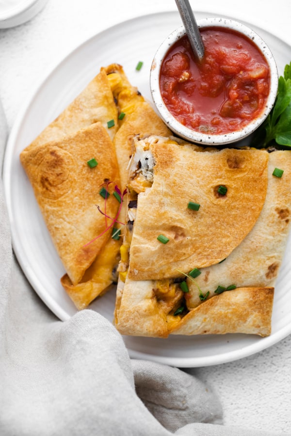sheet pan chicken quesadillas cut on a plate.