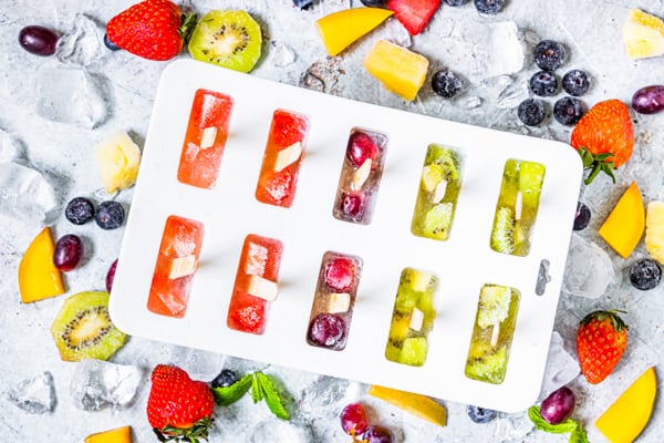 rainbow fruit popsicles in a mold.