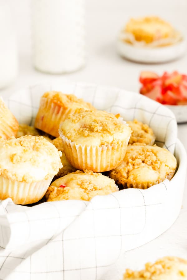 a basket of streusel topped rhubarb muffins.