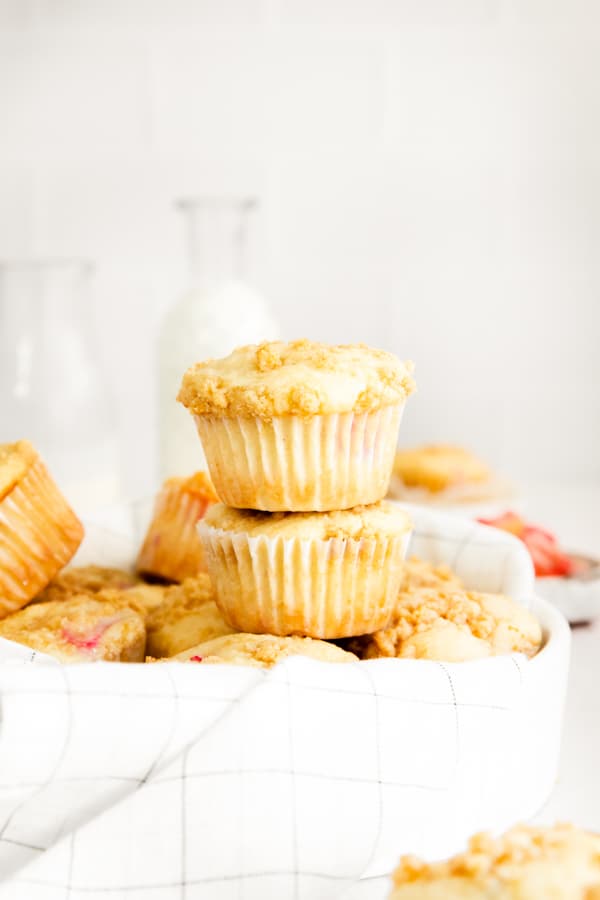 two streusel topped rhubarb muffins stacked on top of each other. 