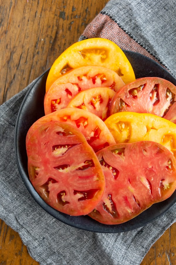 A plate with sliced tomatoes on it.