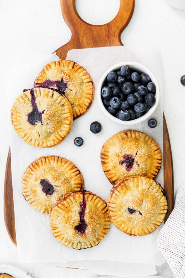 Easy Blueberry Hand Pies on a wooden serving tray. 