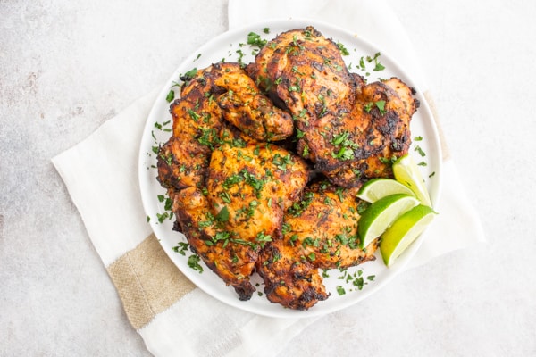 Grilled Cilantro Lime Chicken Thighs on a white plate.