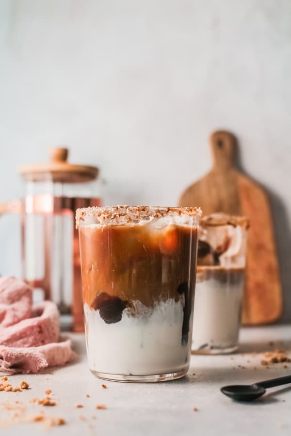 S'mores Iced Coffee in a glass waiting to be topped with marshmallow fluff.