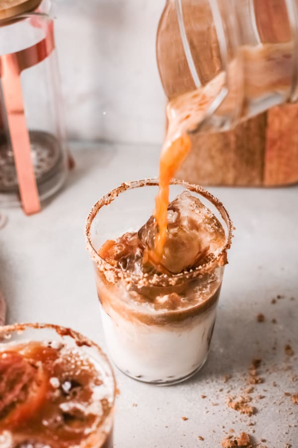 coffee being poured into a glass for S'mores Iced Coffee.