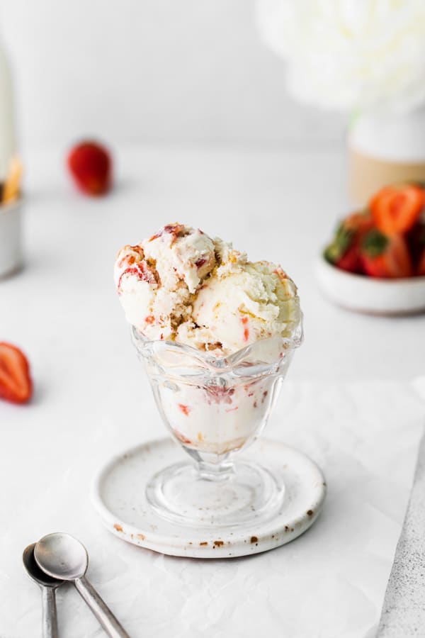 strawberry cheesecake ice cream in a glass ice cream cup. 