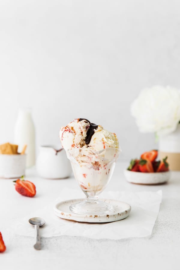 strawberry cheesecake ice cream covered in chocolate sauce. 