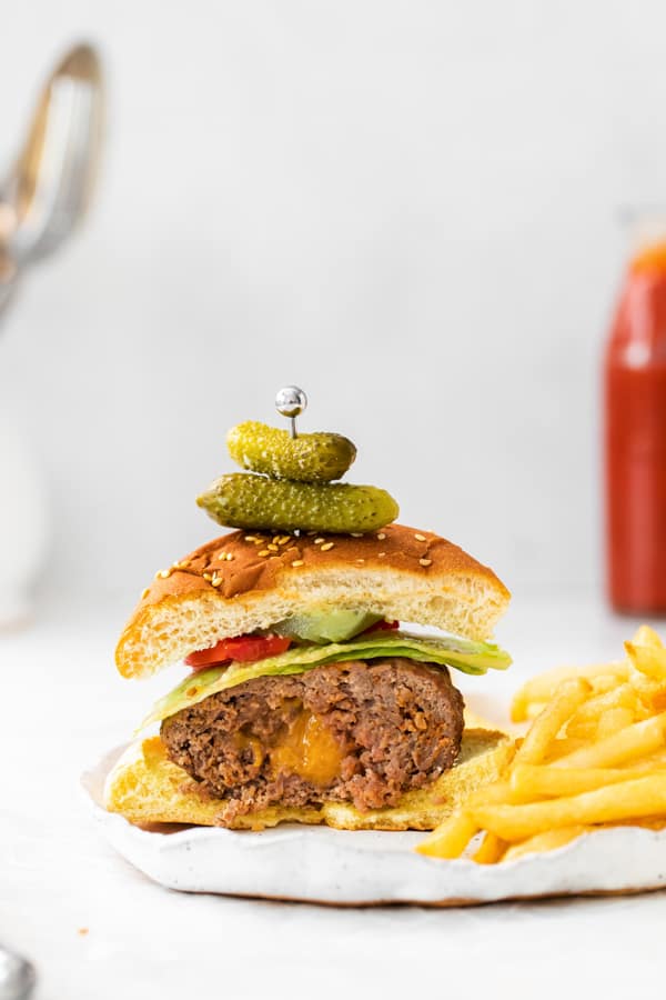 air fryer Juicy Lucy burger cut in half so you can see the cheese in the middle. 