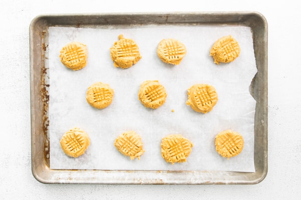 Brown Butter Peanut Butter Cookies uncooked on a sheet pan. 