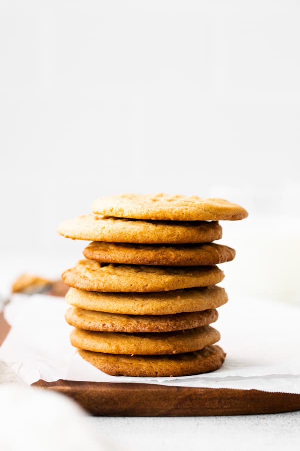 Brown Butter Peanut Butter Cookies stacked up on a serving platter. 