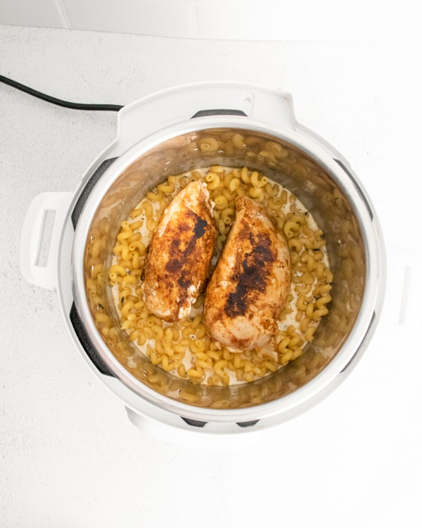 Ingredients for Instant Pot Cajun Chicken Alfredo inside the Instant Pot.