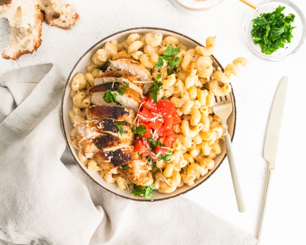 Instant Pot Cajun Chicken Alfredo served with bread and extra Parmesan.
