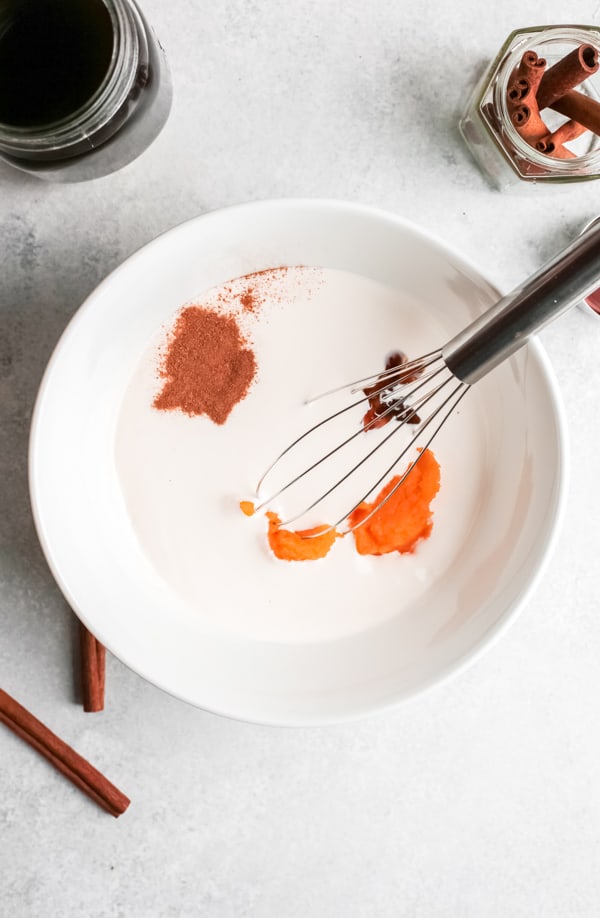 Ingredients in a bowl for pumpkin cream.