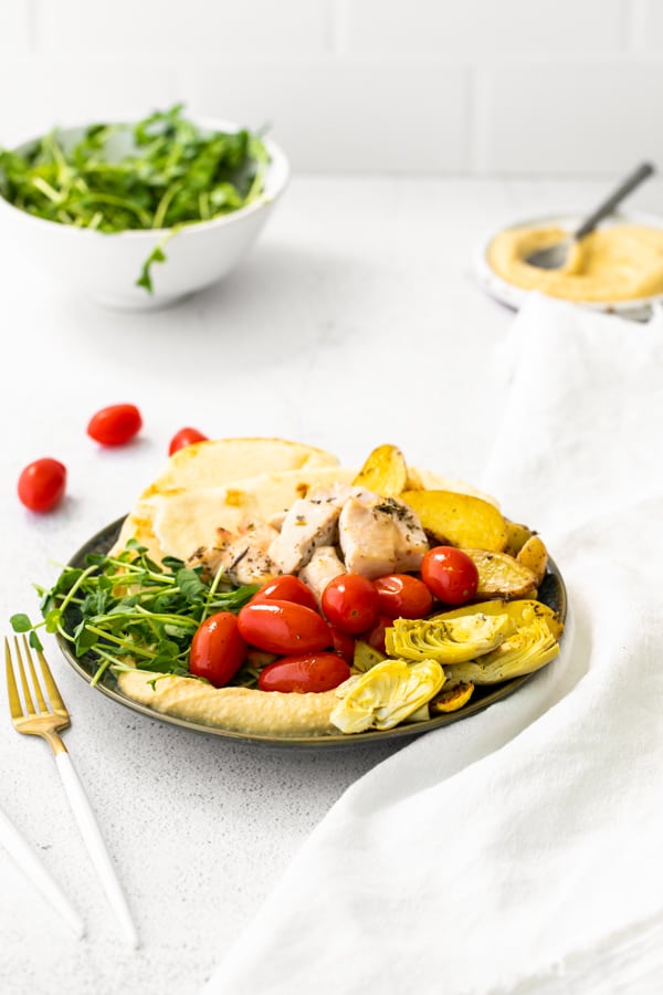 Sheet Pan Mediterranean Chicken plated on a ceramic plate.