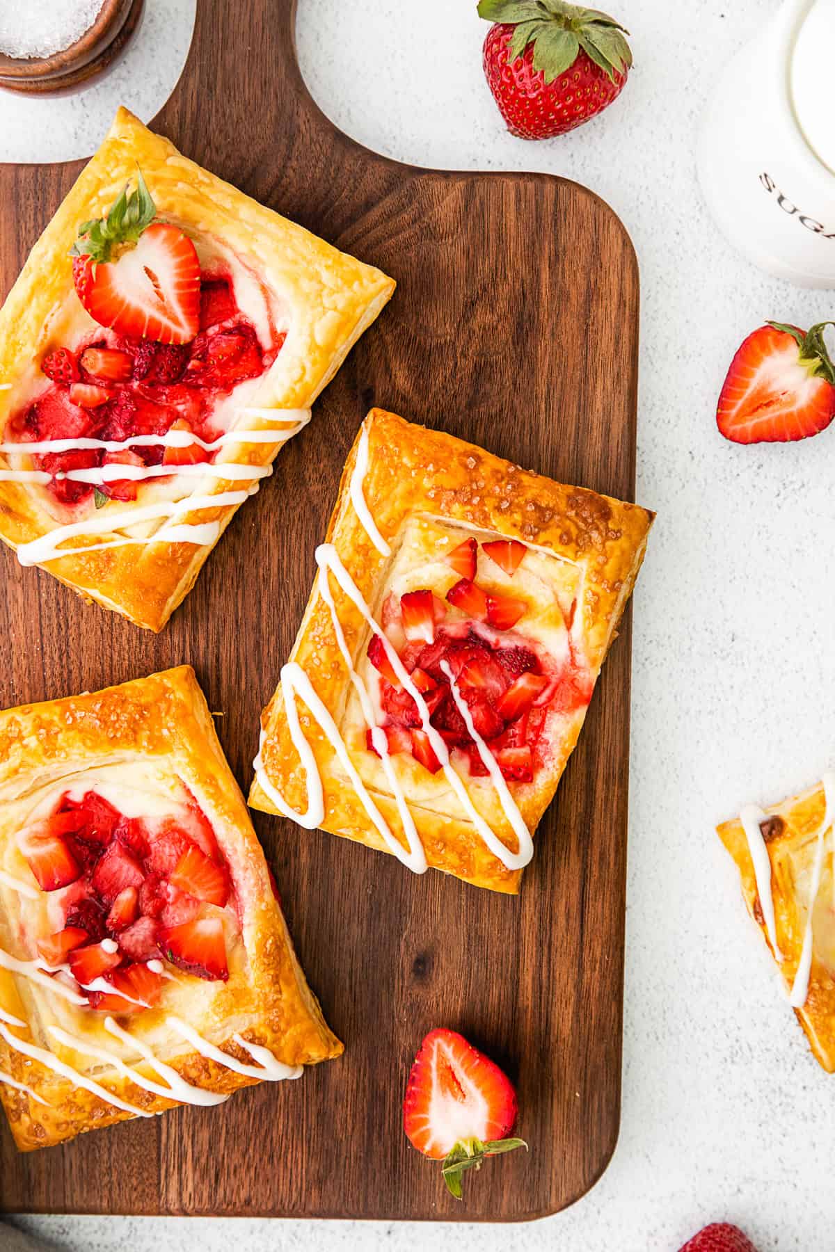 easy strawberry cheesecake Danish topped with glaze and fresh berries. 