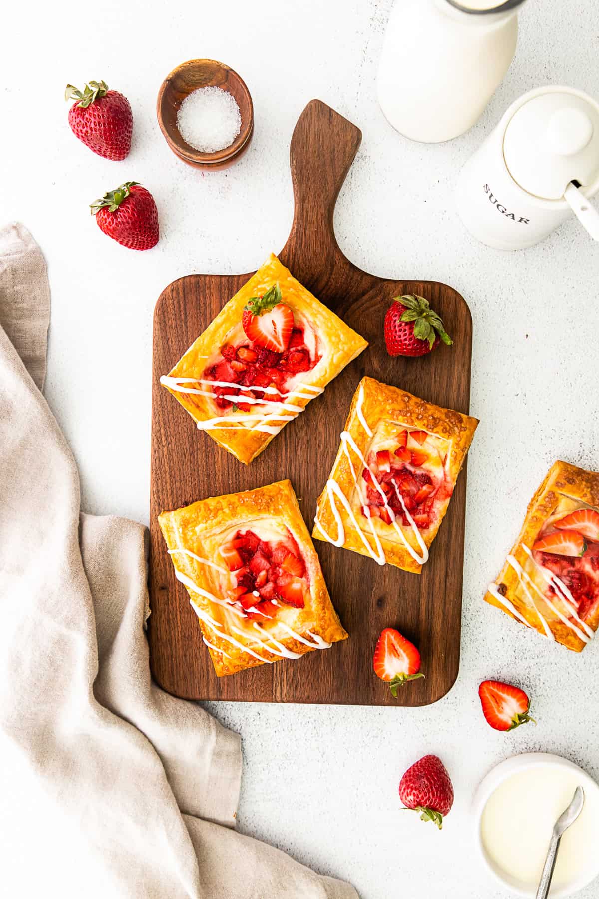 easy strawberry cheesecake Danish sitting on a cutting board. 
