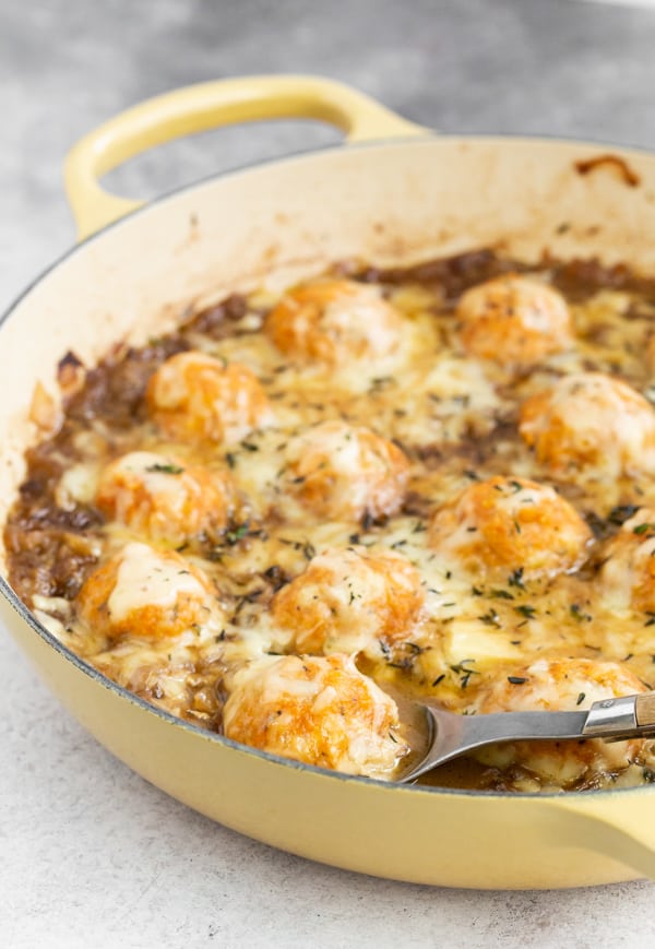 French Onion Chicken Meatballs in a pan being scooped out. 