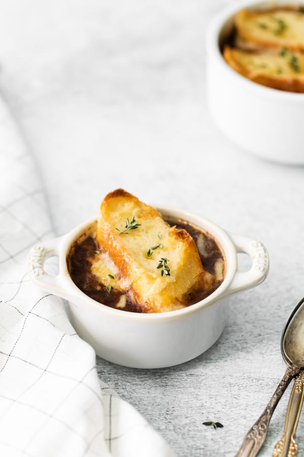 French Onion Soup garnished with fresh thyme. 