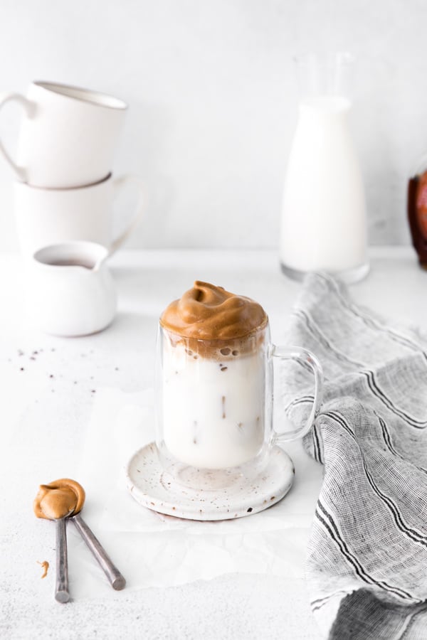 Maple Whipped Coffee served in a glass cup with ice. 