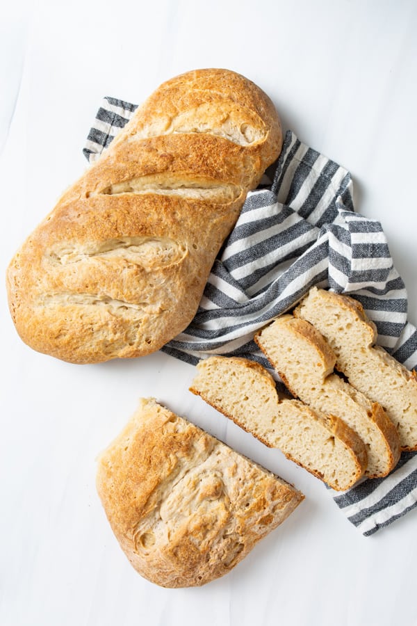 Two loaves of No Yeast Sourdough Bread sitting on a marble serving tray.