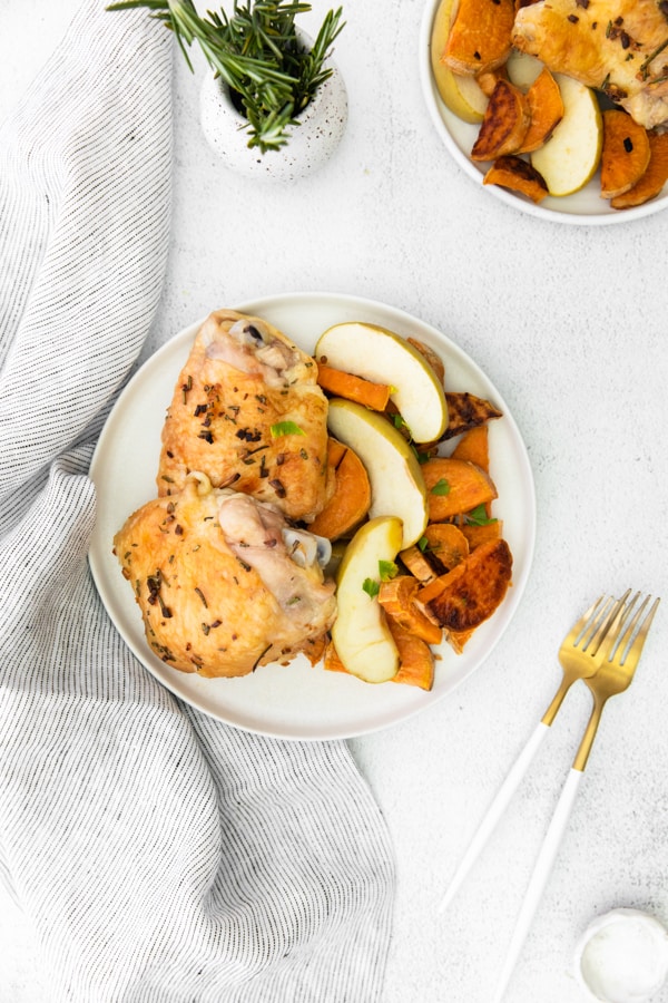 Sheet Pan Chicken and Apples served on white plates.