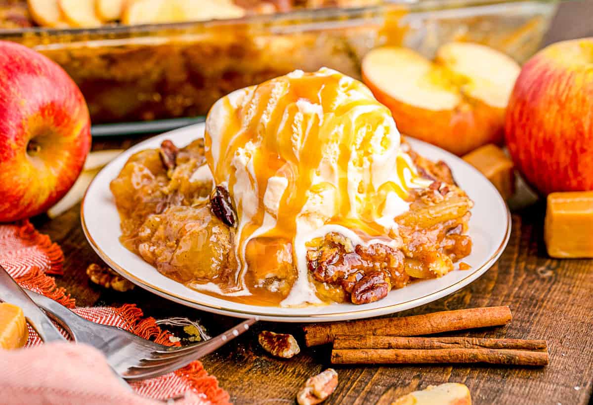 Caramel Apple Dump Cake on a plate with ice cream. 