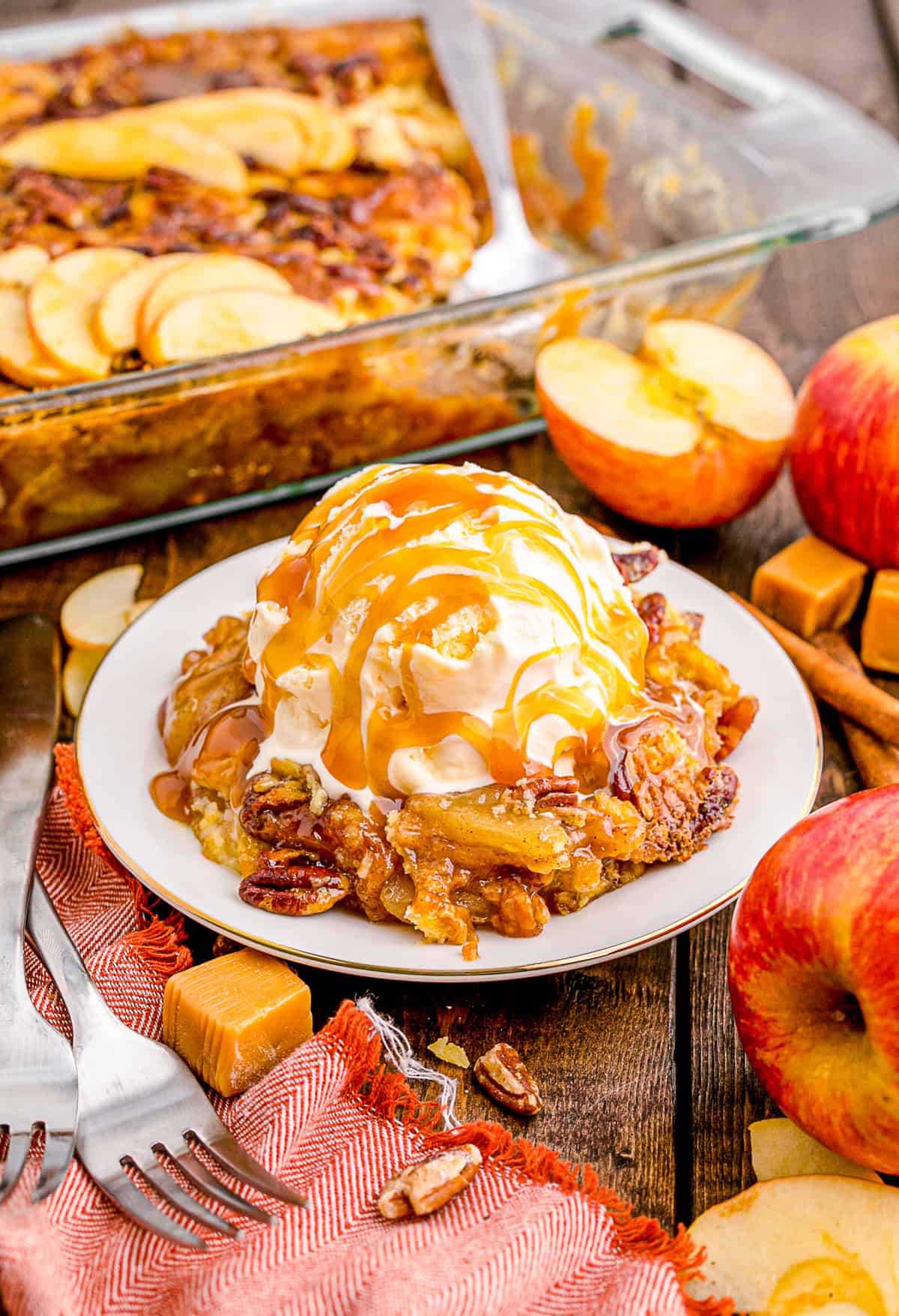 Caramel Apple Dump Cake topped with ice cream with caramel. 