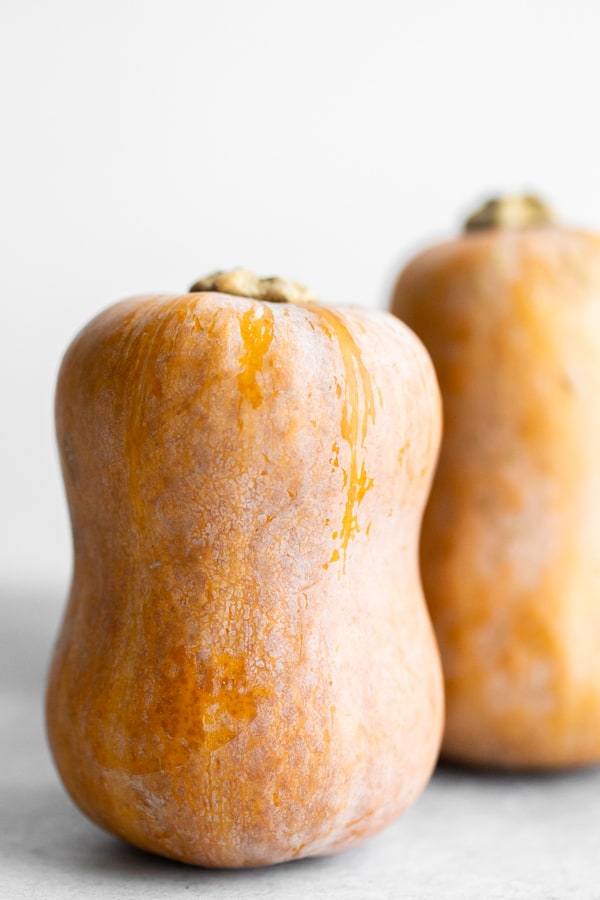 two honeynut squash sitting on a table.